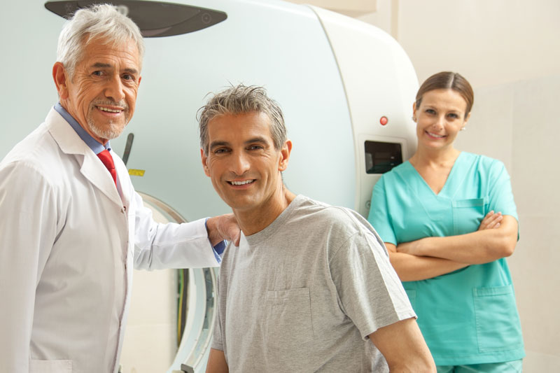 Doctor with patient and nurse in front of MRI