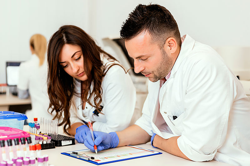 Two researchers reviewing results